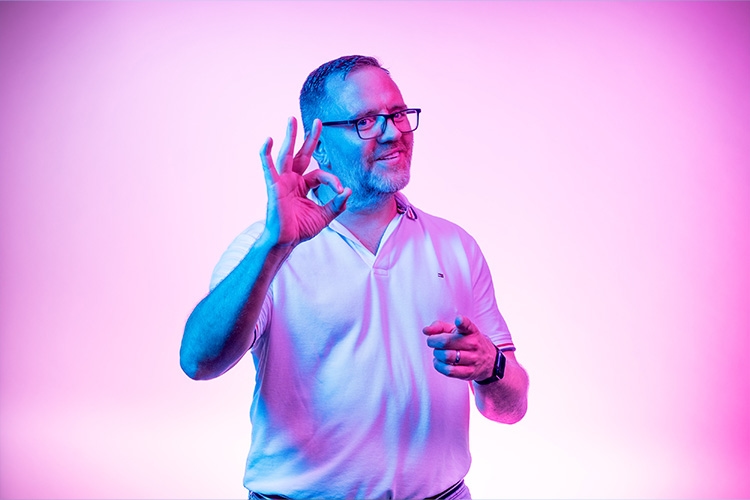 Man points OK with thumb and index finger